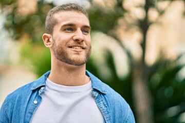 Young caucasian man smiling happy standing at the park.