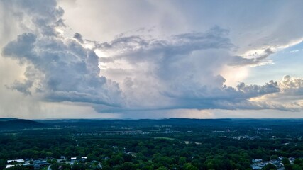 Thunderstorm clouds moving into an area with rain falling from the front of the storm.