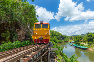 Fototapeta premium trains running on death railways track crossing kwai river in kanchanaburi thailand this railways important destination of world war II history builted by soldier prisoners