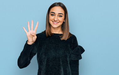 Beautiful brunette woman wearing elegant sweater showing and pointing up with fingers number four while smiling confident and happy.