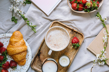 Coffee in bed. Weekend breakfast with drink and croissant, flat style, top view