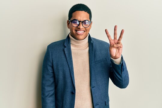 Young handsome hispanic man wearing elegant clothes and glasses showing and pointing up with fingers number three while smiling confident and happy.