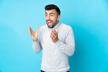 Caucasian man over isolated blue background with surprise facial expression