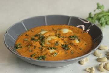 Egg butter masala. Boiled eggs in a rich creamy gravy of onions, tomatoes, cashew nuts and spices.