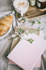 Flat lay summer mood plan. Diary and coffee with croissant in beige