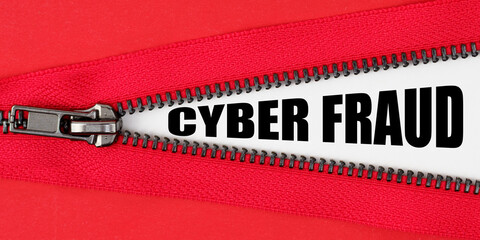 Against the background of red fabric, a zipper opens, on the white surface the inscription - CYBER...