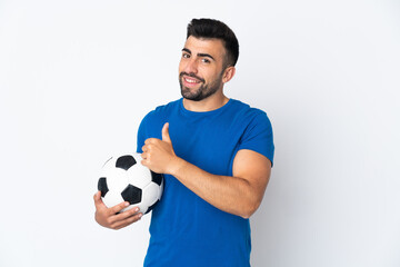 Handsome young football player man over isolated wall giving a thumbs up gesture