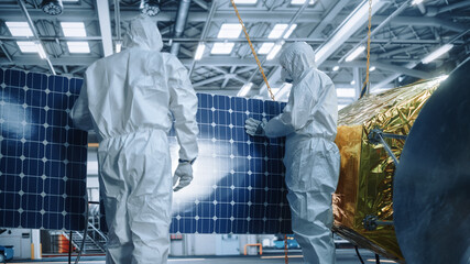 Engineer and Technician in Protective Suits Working on Satellite Construction. Aerospace Agency:...