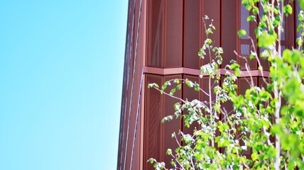 A fragment of the steel facade of office building.  Modern architecture building facade. Metal details of the facade