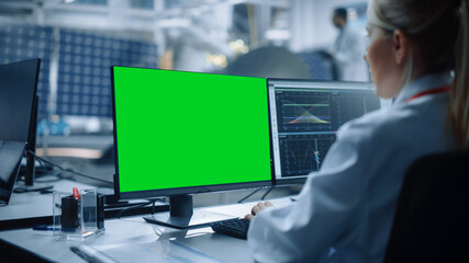 Female Engineer uses Green Screen Computer to Analyse Satellite. Aerospace Agency Manufacturing...