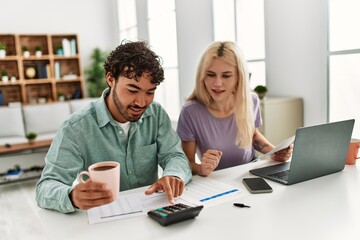 Fototapeta premium Young couple controlling family economy at home.