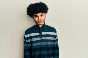 Fototapeta na wymiar Young african american man with afro hair wearing casual clothes skeptic and nervous, frowning upset because of problem. negative person.