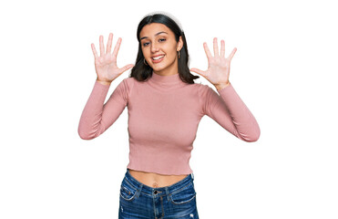Young hispanic girl wearing casual clothes showing and pointing up with fingers number ten while smiling confident and happy.
