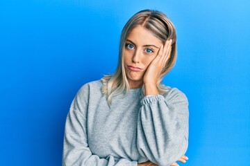 Beautiful blonde woman wearing casual clothes thinking looking tired and bored with depression problems with crossed arms.