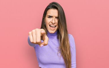 Young hispanic woman wearing casual clothes pointing displeased and frustrated to the camera, angry...