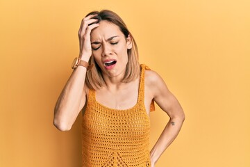 Young caucasian blonde woman wearing casual yellow t shirt yawning tired covering half face, eye and mouth with hand. face hurts in pain.