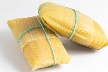 Delicious Brazilian corn snack, pamonha, on white background.