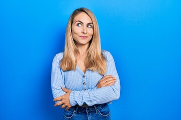 Young caucasian woman wearing casual clothes smiling looking to the side and staring away thinking.