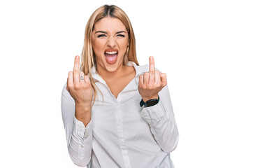 Young caucasian woman wearing casual clothes showing middle finger doing fuck you bad expression, provocation and rude attitude. screaming excited