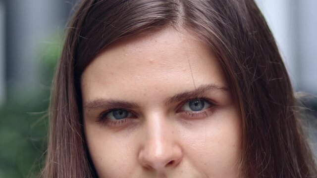 Close up of attractive woman’s Face, Girl opening her Beautiful blue azzure Eyes.