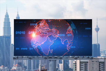 World planet Earth map hologram on billboard over panorama city view of Kuala Lumpur, Malaysia, Asia. The concept of international connections and business.