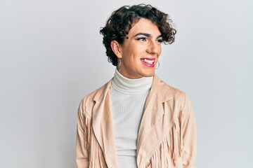 Young man wearing woman make up and woman clothes looking to side, relax profile pose with natural face and confident smile. - obrazy, fototapety, plakaty