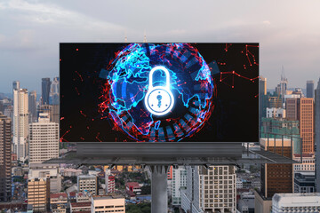 Padlock icon hologram on road billboard over panorama city view of Kuala Lumpur at sunset to protect business, Malaysia, Asia. The concept of information security shields.