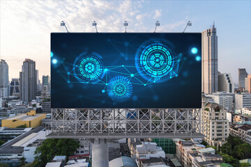 Glowing hologram of technological process on billboard, aerial panoramic cityscape of Bangkok at sunset. The largest innovative hub of tech services in Southeast Asia.