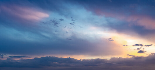  Beautiful bright sunset sky with blue orange clouds. Natural evening sky background