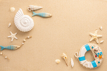 Fototapeta na wymiar Summer sea concept. Ammonite, starfishes,snail shell and lifebuoy on sand. Top view. Copy space.