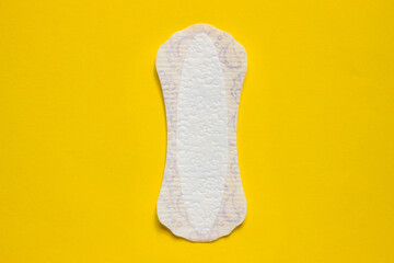 Feminine hygiene panty liner for menstruation. Menstrual cycle, pad. Yellow background. red strawberry.