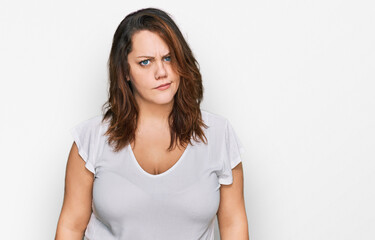Fototapeta premium Young plus size woman wearing casual white t shirt skeptic and nervous, frowning upset because of problem. negative person.