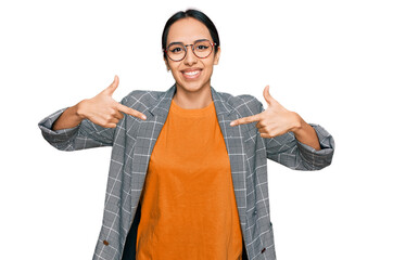Young hispanic girl wearing business jacket and glasses looking confident with smile on face,...