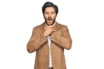 Young hispanic man wearing business clothes shouting suffocate because painful strangle. health problem. asphyxiate and suicide concept.