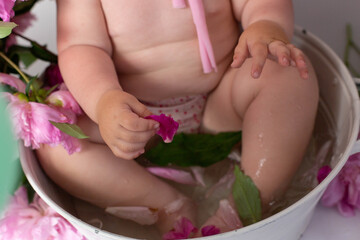 girl in a basin with pink peony flowers