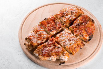 Pinsa romana gourmet italian cuisine on white background. Scrocchiarella. Pinsa with pepperoni, tomatoes, cheese.