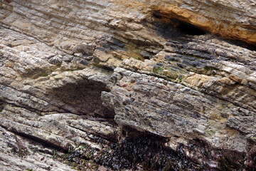 Earth formation with layers of rocks in an California ocean cliff