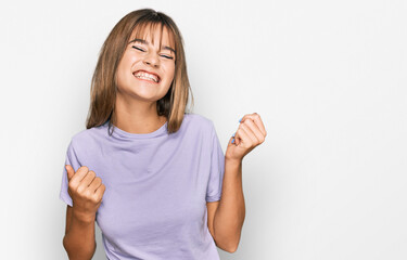 Teenager caucasian girl wearing casual clothes excited for success with arms raised and eyes closed celebrating victory smiling. winner concept.