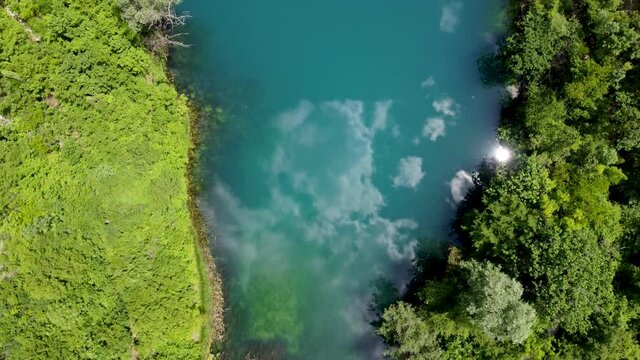 Aerial drone view of river source. Beautiful green river and forest in spring.	