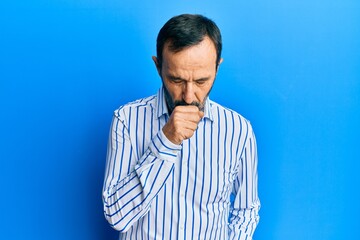 Middle age hispanic man wearing casual clothes feeling unwell and coughing as symptom for cold or bronchitis. health care concept.
