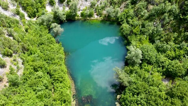 Aerial drone view of river source. Beautiful green river and forest in spring. 