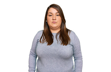 Beautiful brunette plus size woman wearing casual clothes relaxed with serious expression on face....