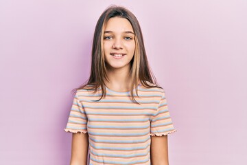 Young brunette girl wearing casual striped t shirt with a happy and cool smile on face. lucky person.