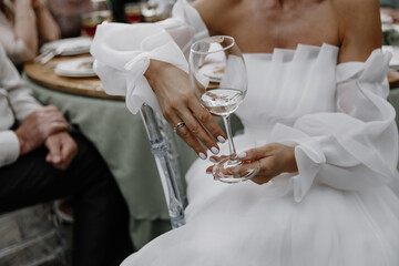 brides hands  with a glass