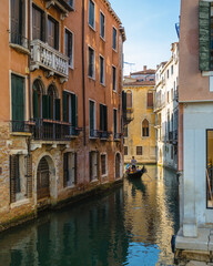 Fototapeta na wymiar Narrow Venice Canal with Gondola