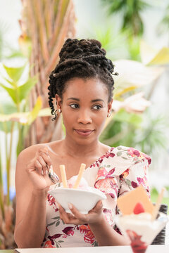 Afro American Woman Smiling And Eating A Sugar Free Ice Cream Desert: Selective Focus And Close Up.