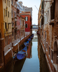Fototapeta na wymiar Gondolas parked along a Venice canal