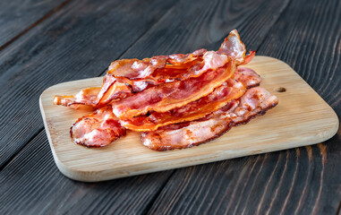 Fried bacon on the cutting board