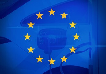 Electric vehicle charging (Ev) station with plug of power cable supply for Ev car with the European Flag.