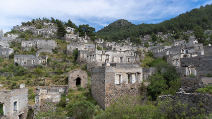 Fototapeta na wymiar Ruins of ancient Lycian town Olympos in Turkey. Abandoned, old, dilapidated, stone houses ancient city in Turkey